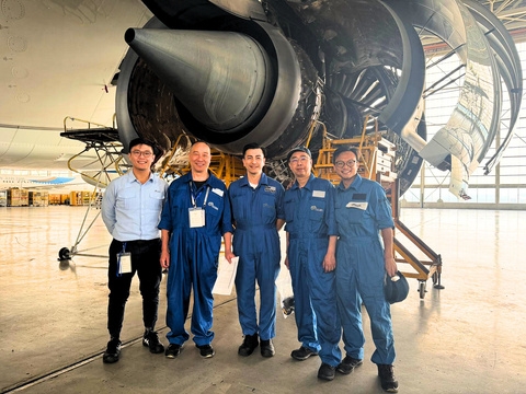 Engineer inspecting aero engine