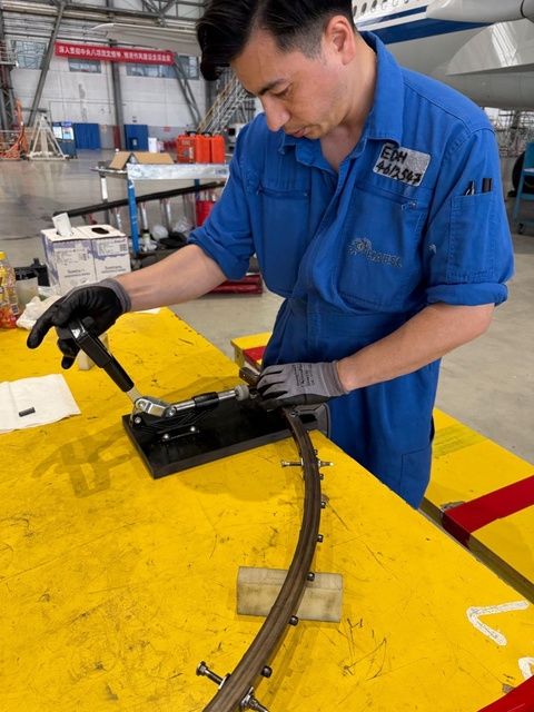 Engineer inspecting aero engine